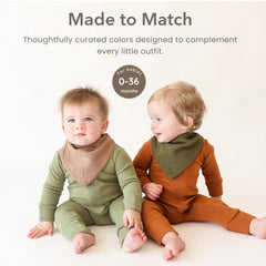 Konssy bibs on infant model demonstrating comfortable coverage benefit
