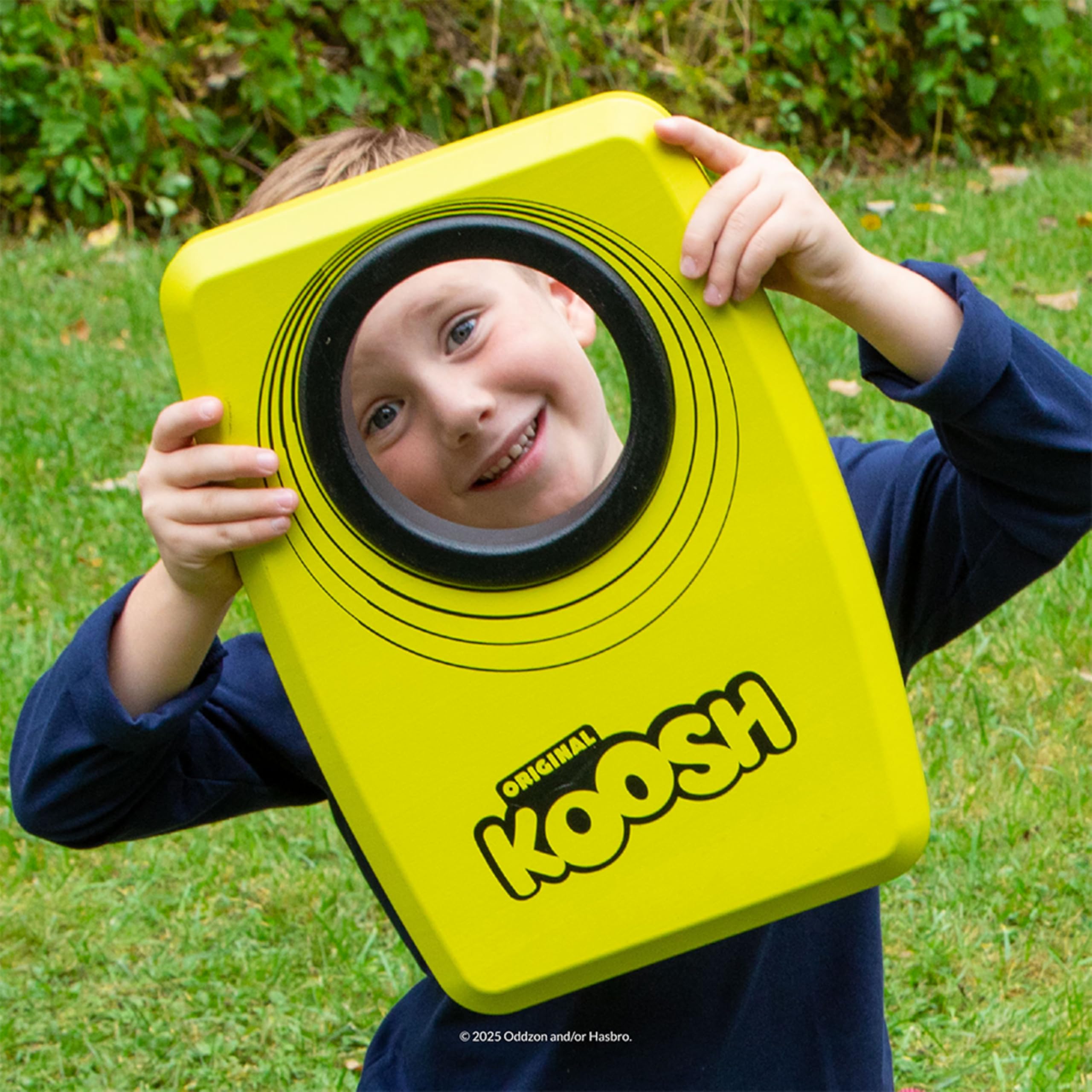 Koosh kids tossing balls in backyard demonstrating family fun and active play benefit