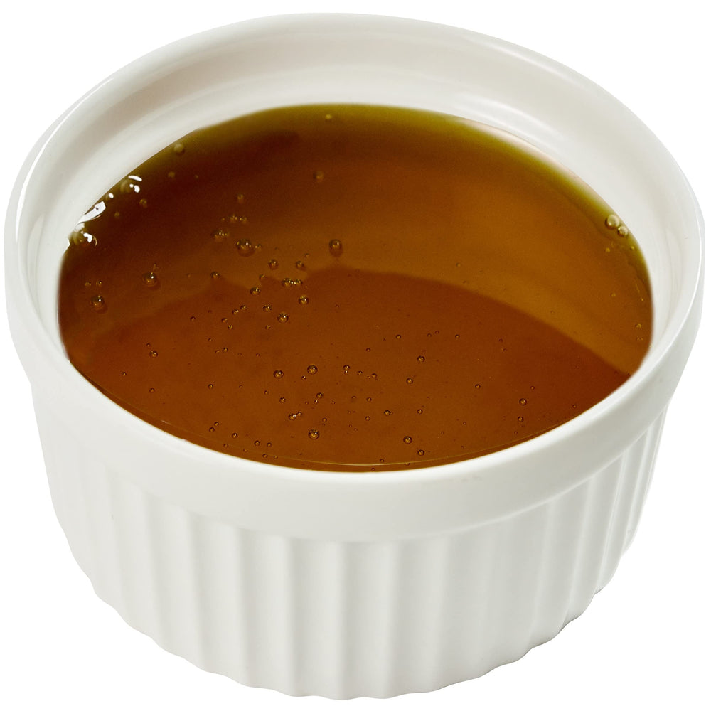 Kraft honey packet next to teaspoon showing portion control and consistency