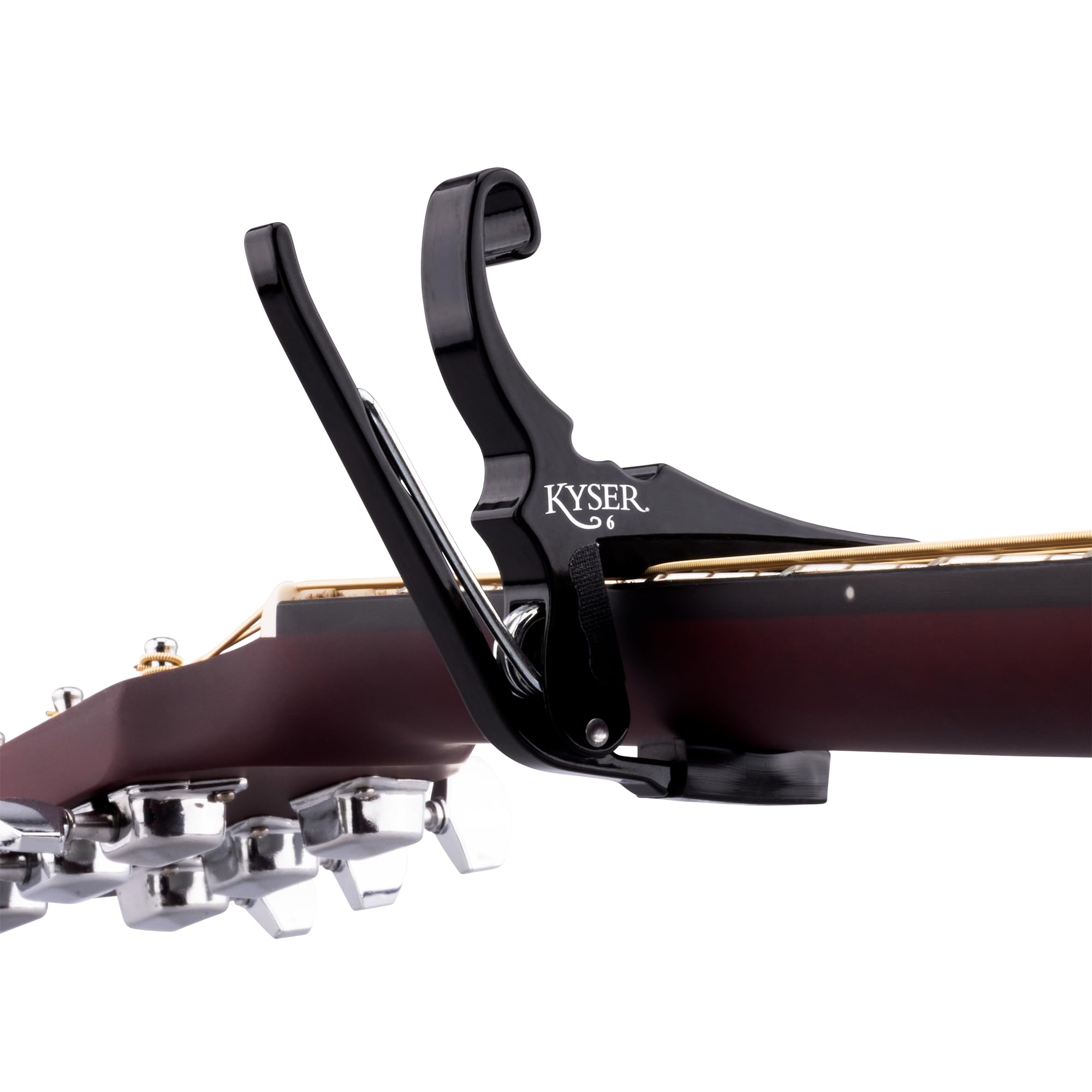 Kyser capo clamped on acoustic fretboard for fast key changes