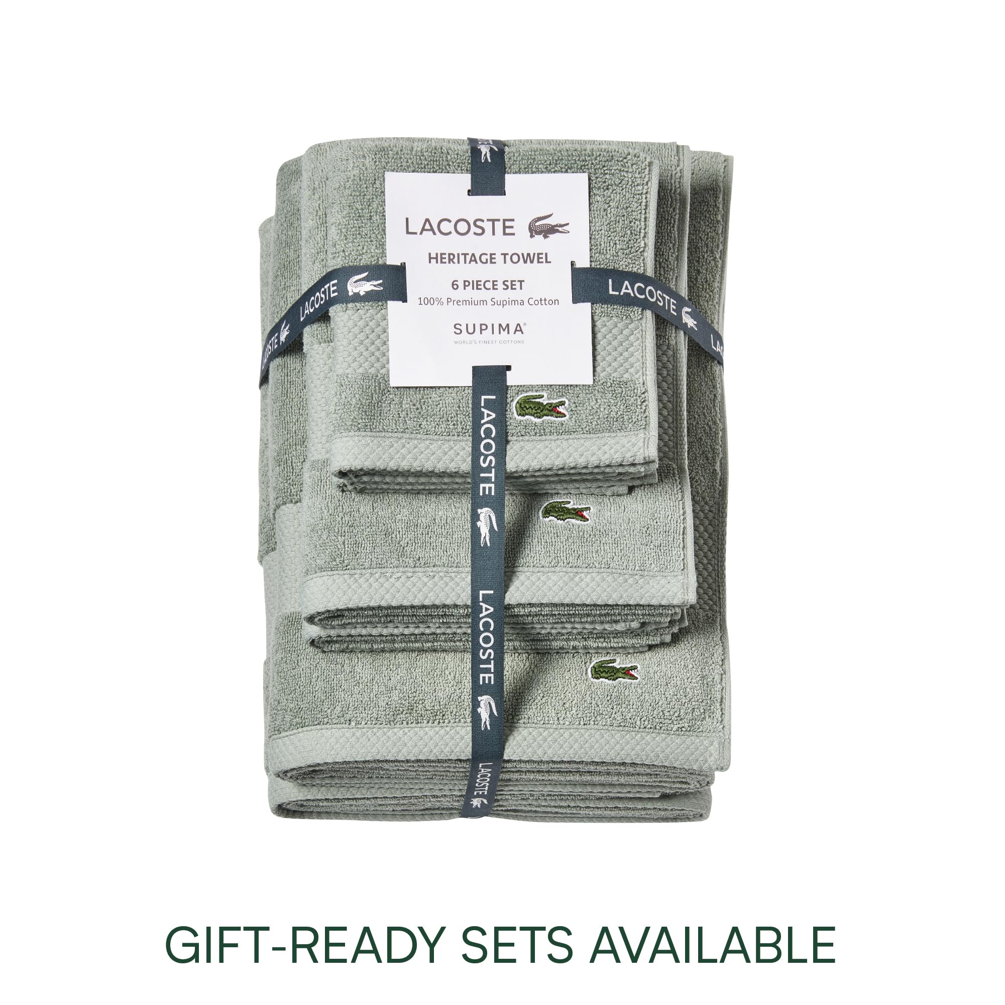 Lacoste folded towels stacked in bathroom for coordinated décor benefit