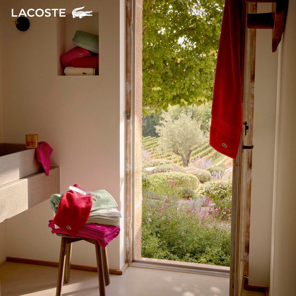 Lacoste towel in a spa-style bathroom conveying calm, luxurious feel