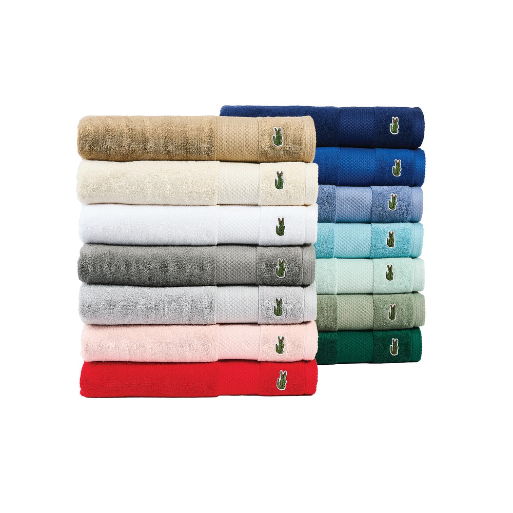 Lacoste towel next to a ruler showing 30x54 size for scale