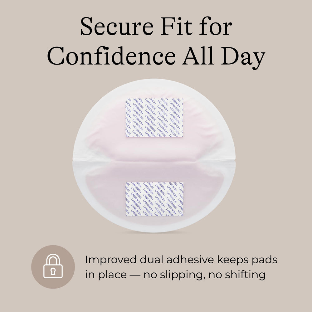 Lansinoh pad next to coin to show compact size and discreet profile