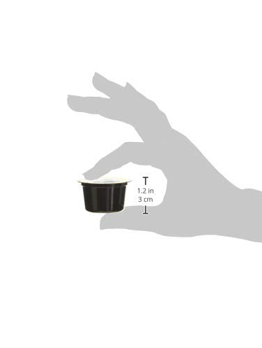 Lavazza Blue capsule beside a coin to show size and convenient portion control