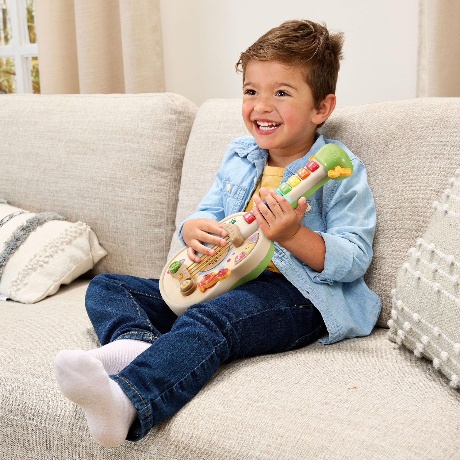 LeapFrog toddler playing with guitar boosting motor skills and creativity