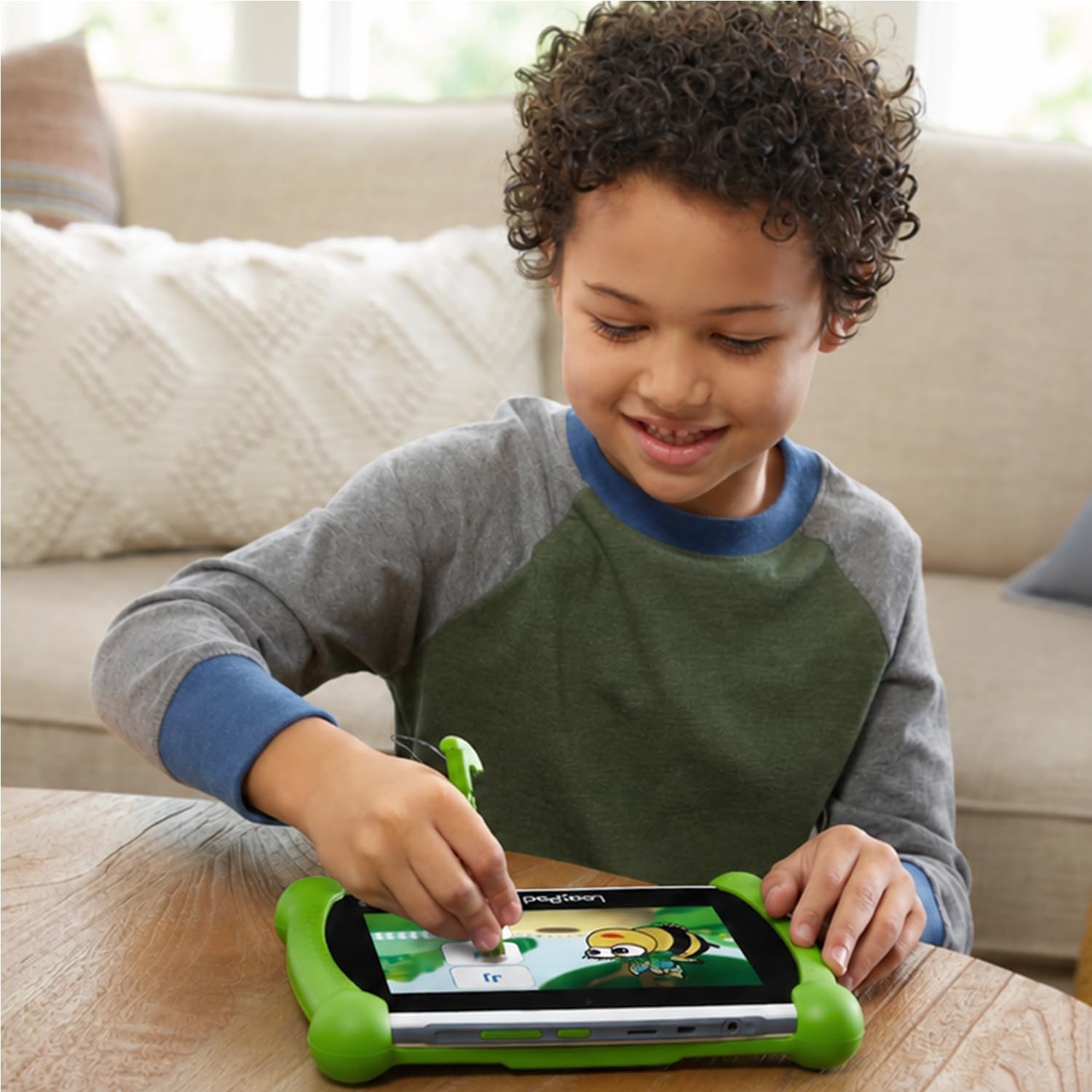 Child using LeapFrog tablet playing an educational app to build skills