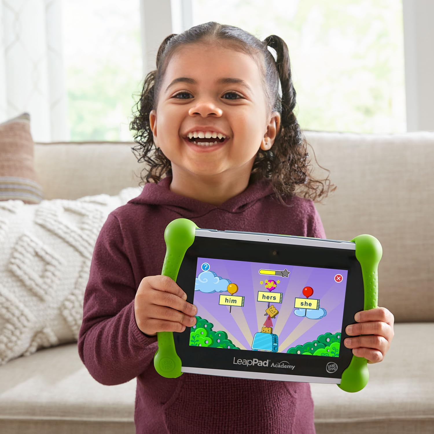 Size comparison with child hand showing LeapFrog tablet portability and grip