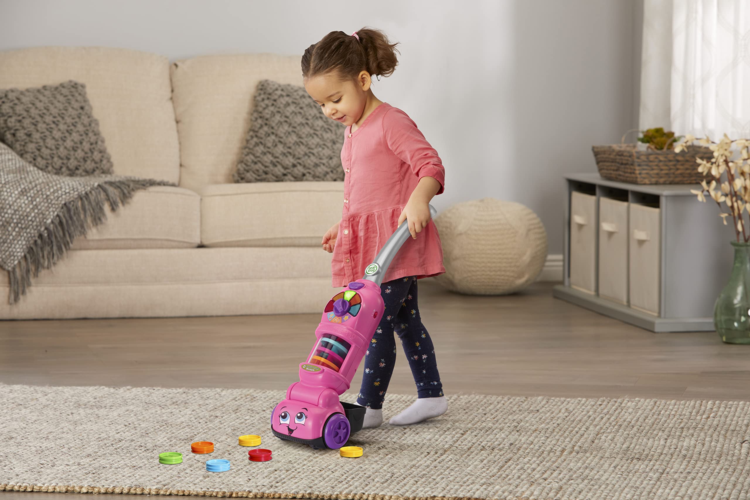 LeapFrog vacuum next to toddler to show product scale and ease of use