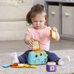 LeapFrog Yum-2-3 Toaster mid-pop with toast up demonstrating cause-and-effect and fun sounds