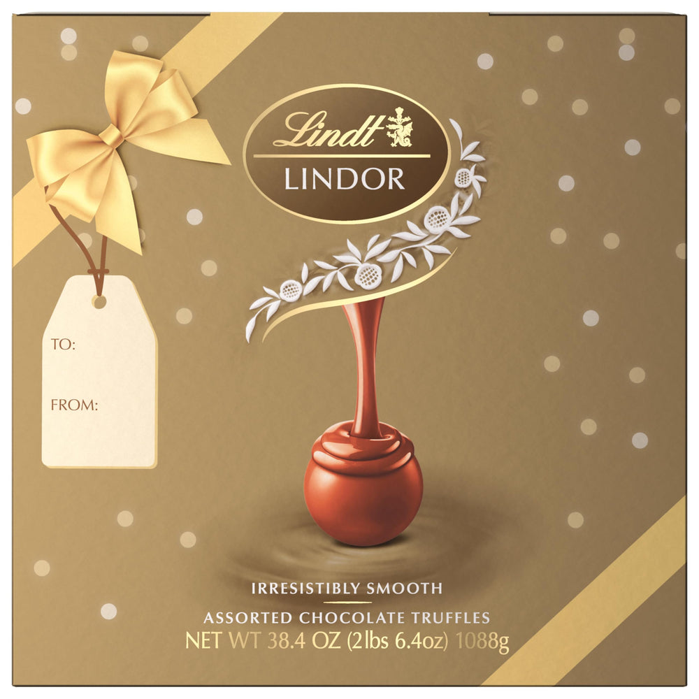 Lindt LINDOR truffle in hand showing scale and portioning benefit