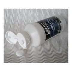 Liquitex clear gesso beside a paint tube for scale, compact 237ml bottle ideal for studios