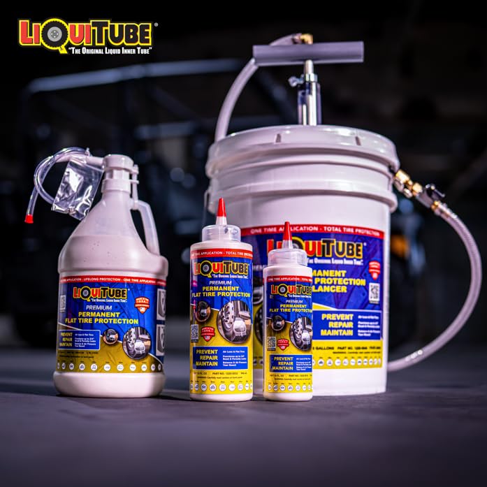 Trailer wheel being treated with LiquiTube in a driveway, illustrating fleet and homeowner use