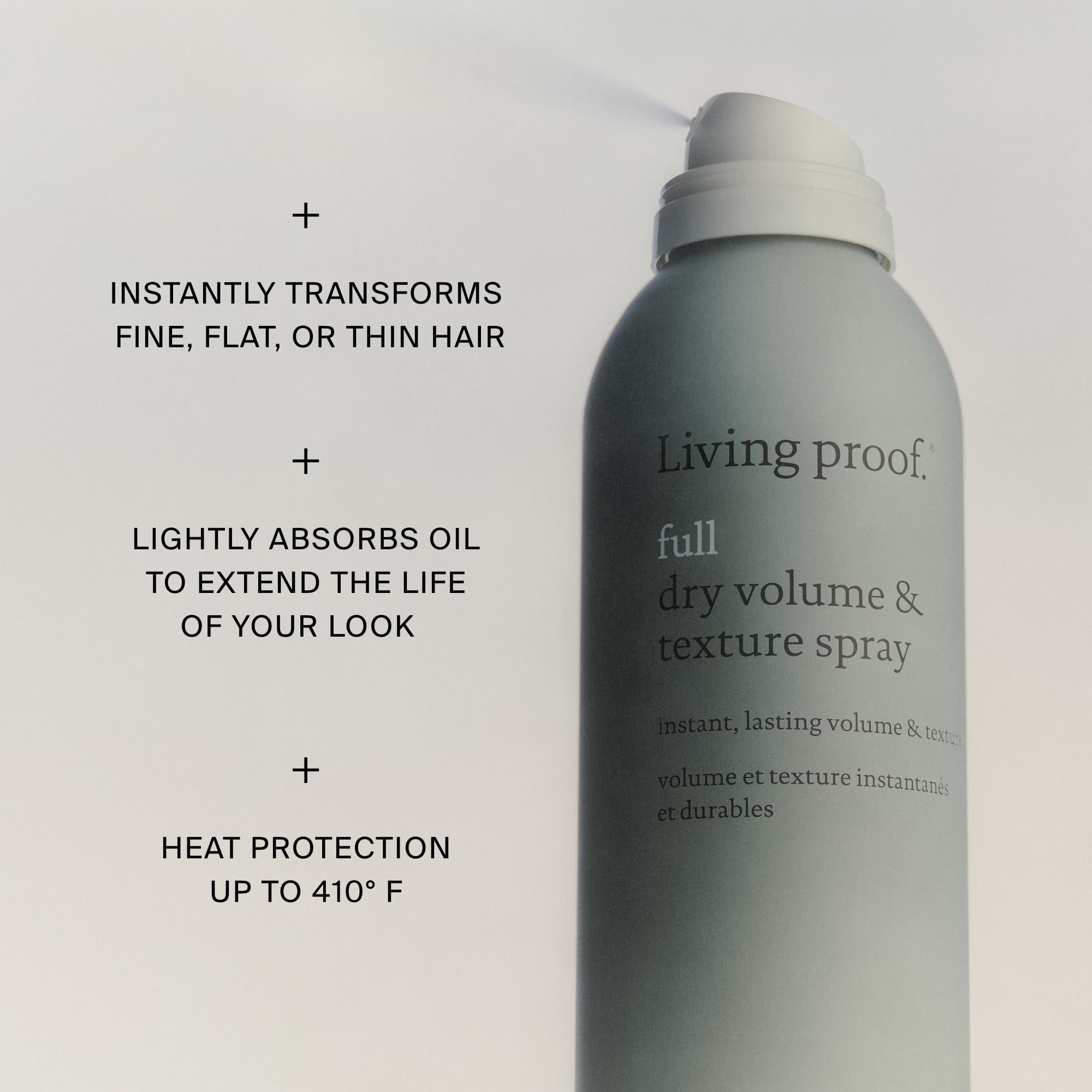 Living Proof texture spray held in hand illustrating lightweight control and grip