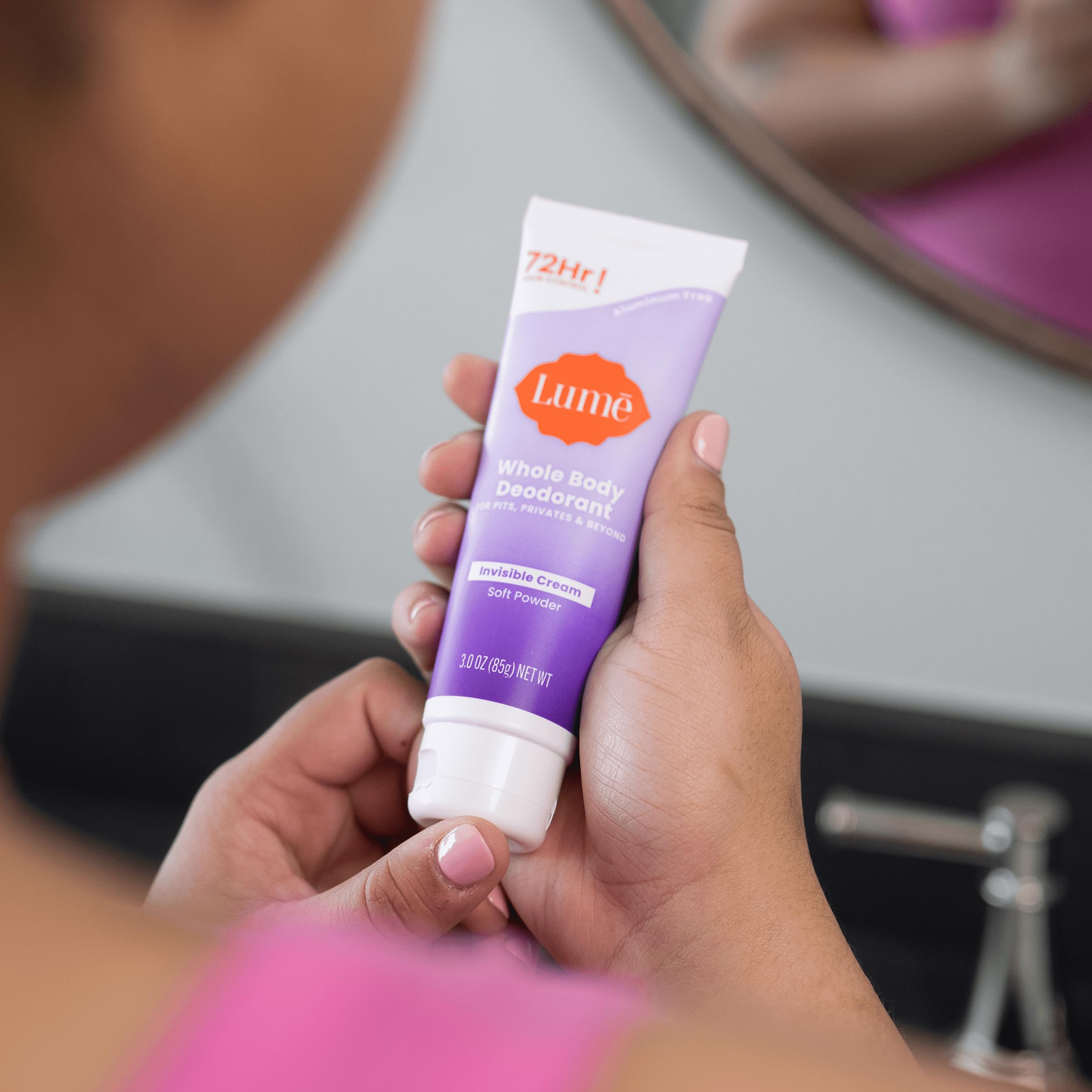 Applying Lume underarm to illustrate effective pit odor control and invisible finish