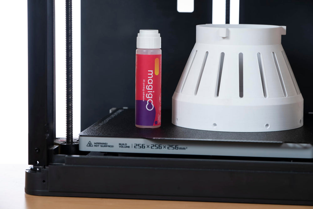 Magigoo 50mL bottle next to a ruler showing compact size and portability