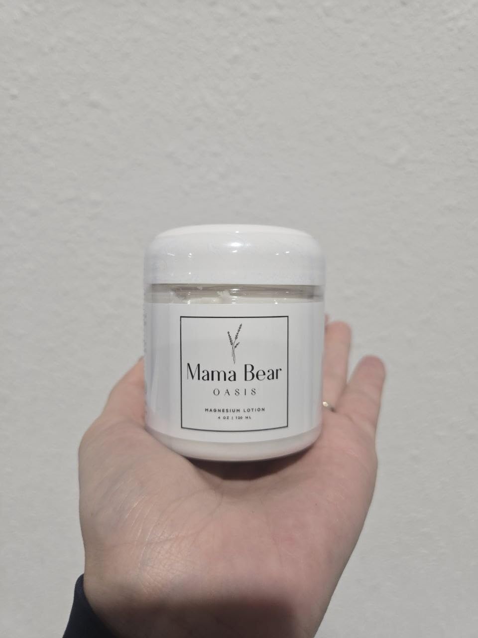Mama Bear Oasis applying cream to feet demonstrating easy absorption benefit