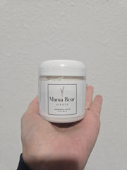 Mama Bear Oasis applying cream to feet demonstrating easy absorption benefit