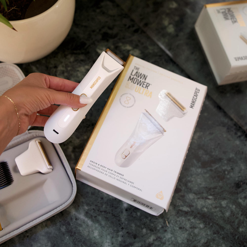MANSCAPED trimmer next to hand showing compact, travel-ready scale