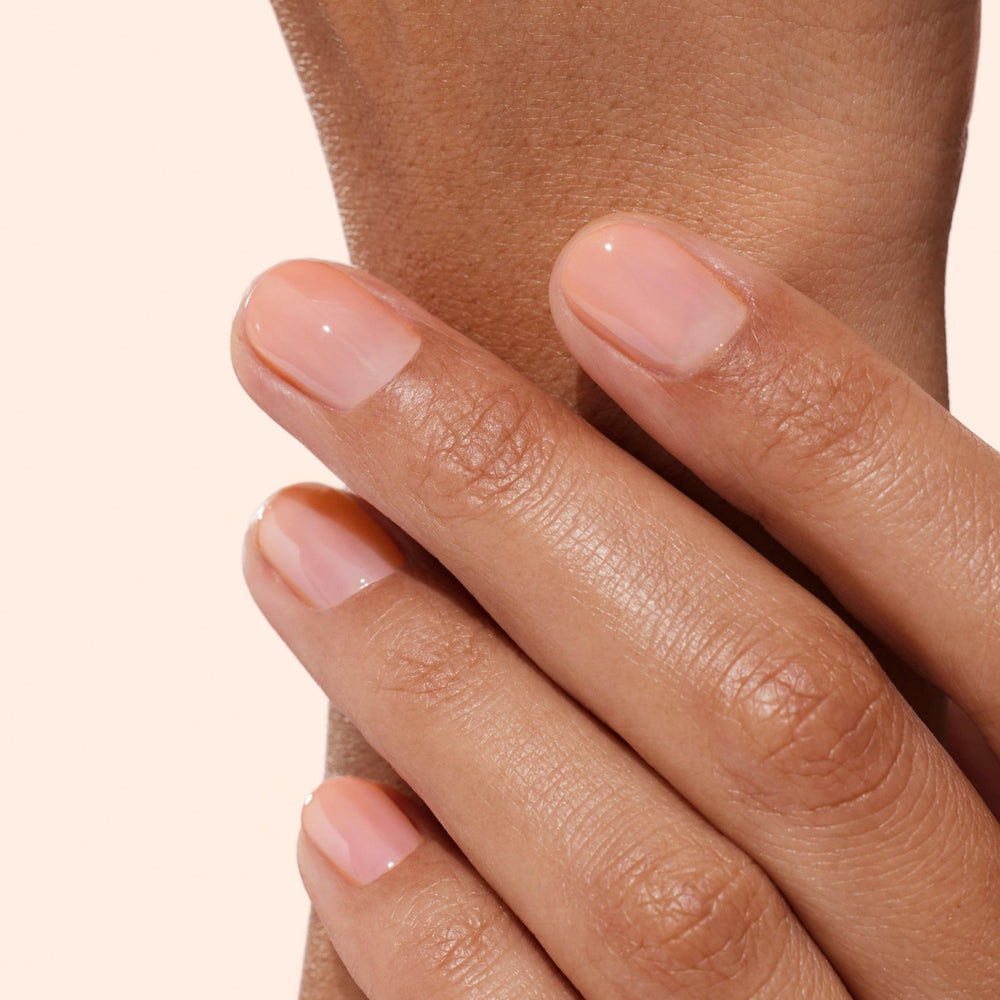Manucurist brush applying a smooth stroke for even coverage and quick-dry finish