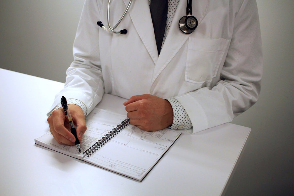 Medical Basics notebook in white coat pocket showing compact size for portability