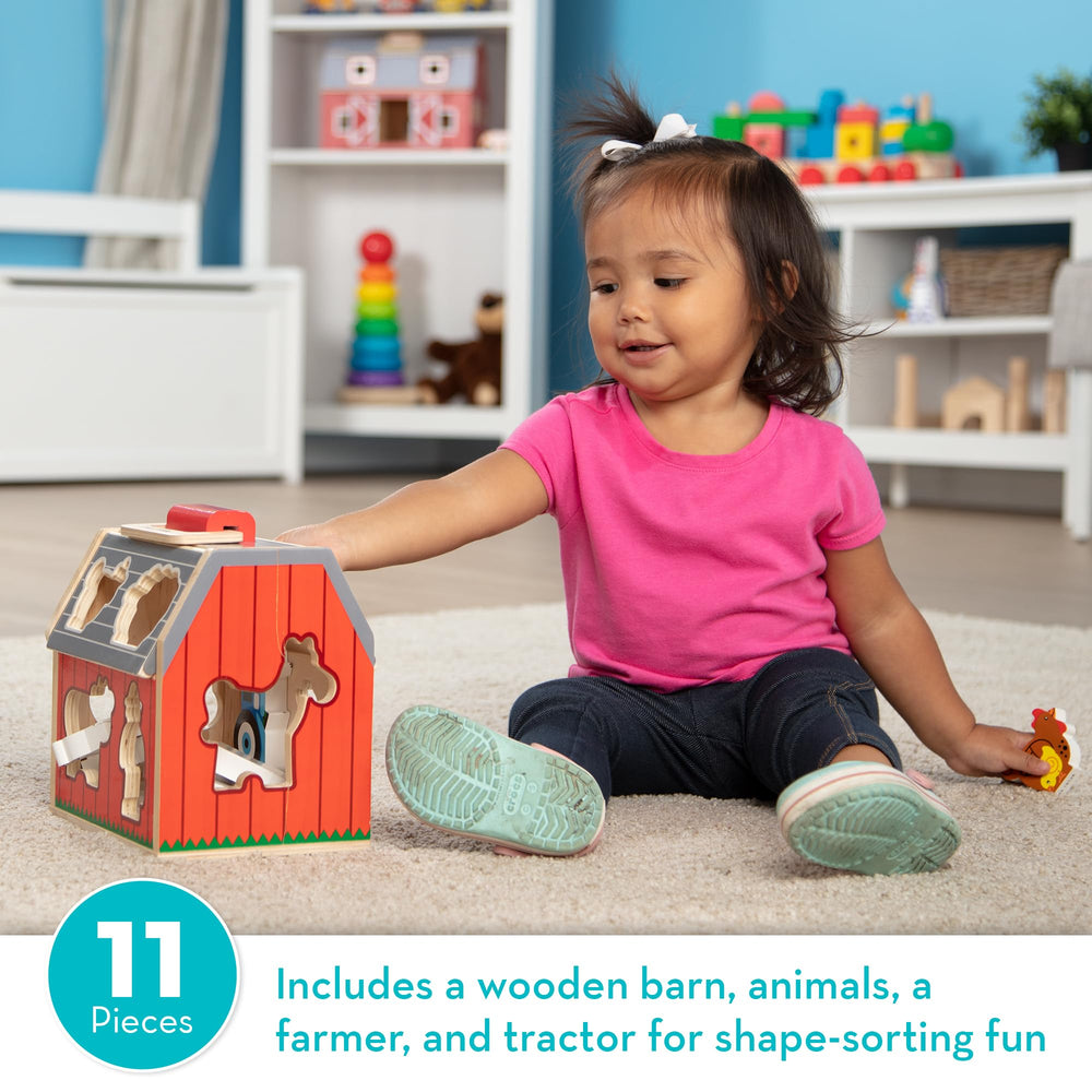 Melissa & Doug built-in handle on barn being carried, shows easy portability for travel