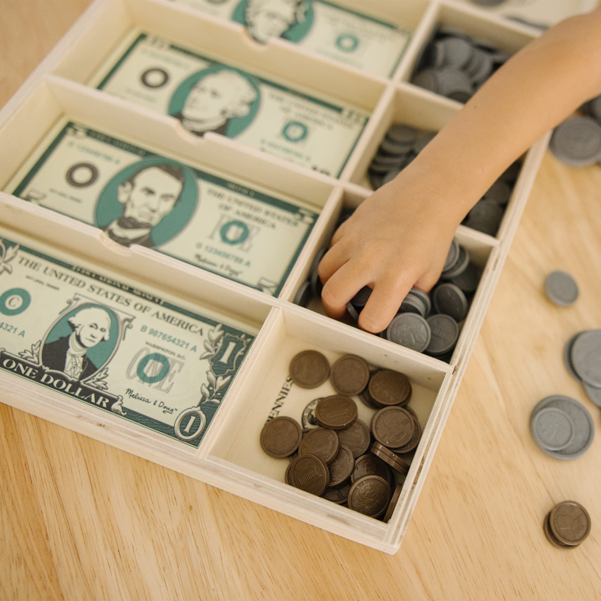 Melissa & Doug play money used at a kitchen lemonade stand for imaginative play