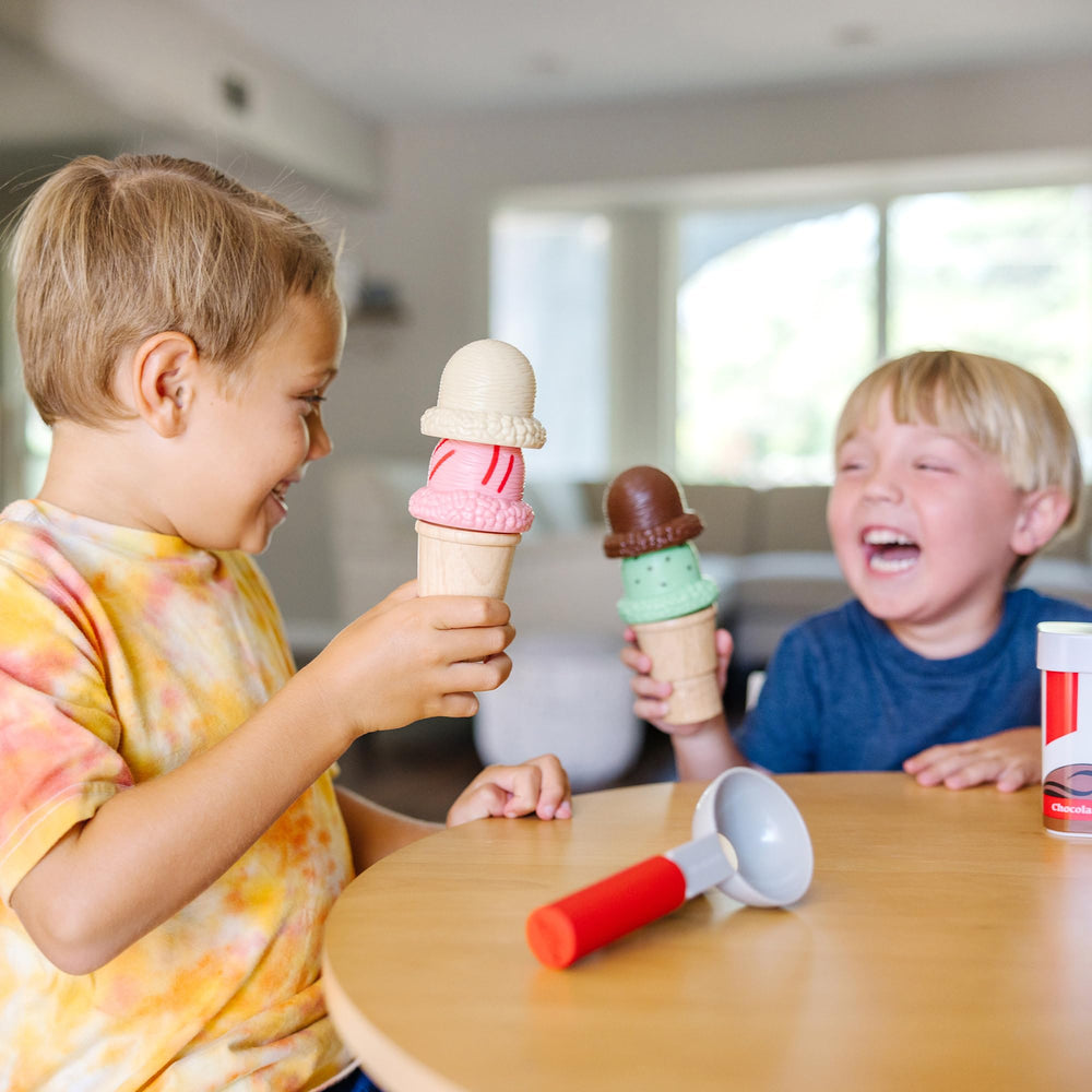 Melissa & Doug hand holding scooper to show child-sized scale