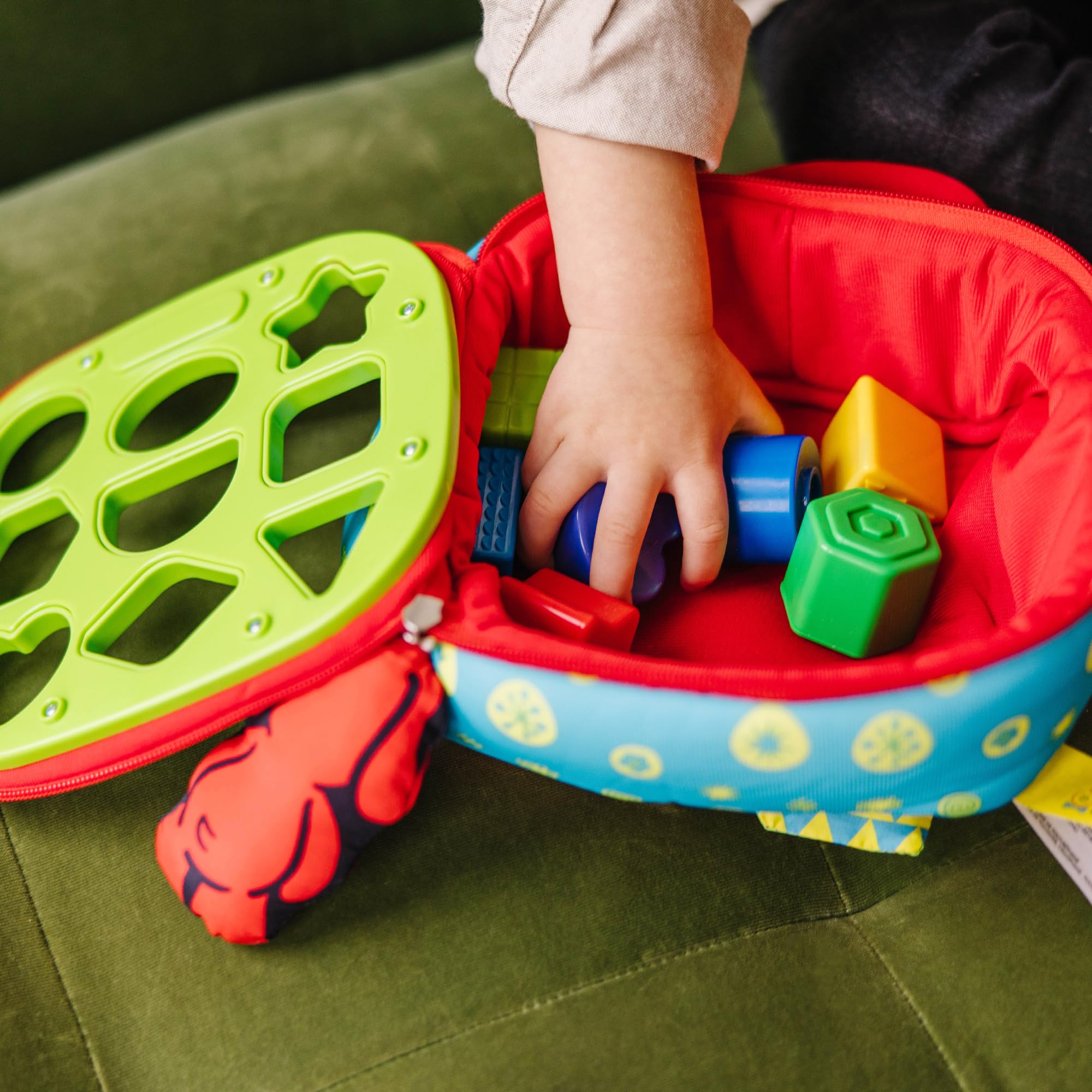 Melissa & Doug size comparison with adult hand to show block dimensions and safe toddler scale