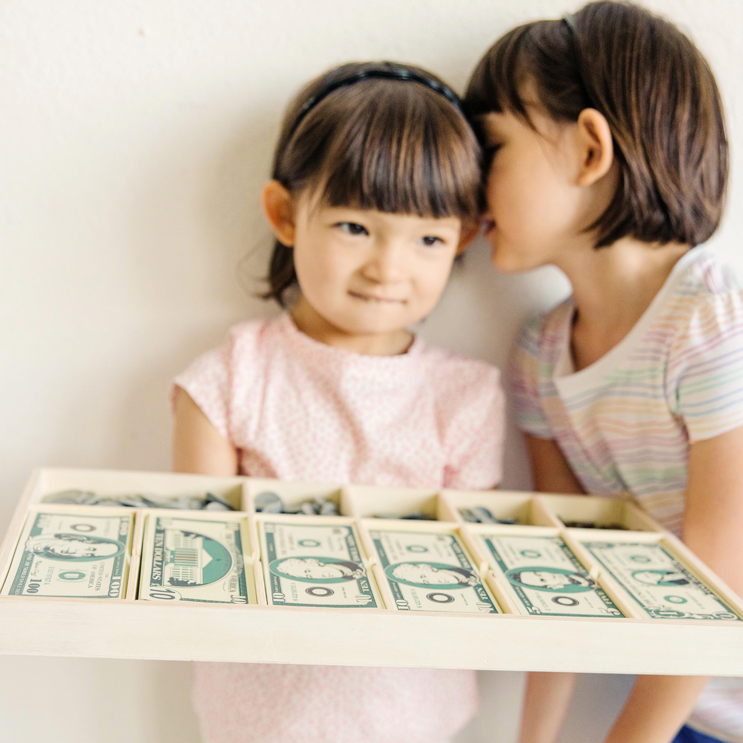 Melissa & Doug coins and bills next to ruler showing real-size scale