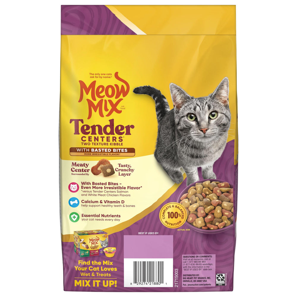 Hand holding kibble for scale showing Meow Mix portion size