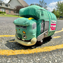 MerryMakers Trash Truck plush next to child to show 11-inch size and travel-friendly benefit