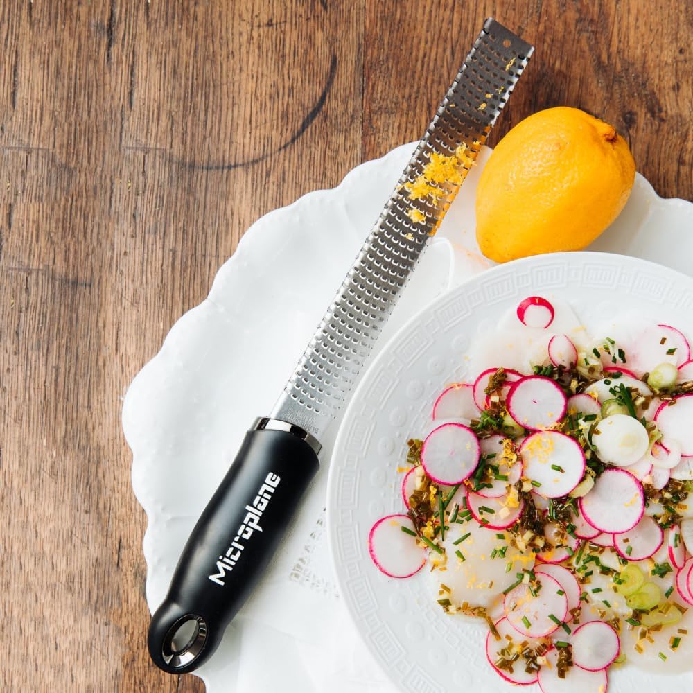 Microplane grating ginger and nutmeg into fresh aromatic shavings