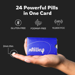 Milky tablet held in hand to show size and easy dosing for on-the-go relief