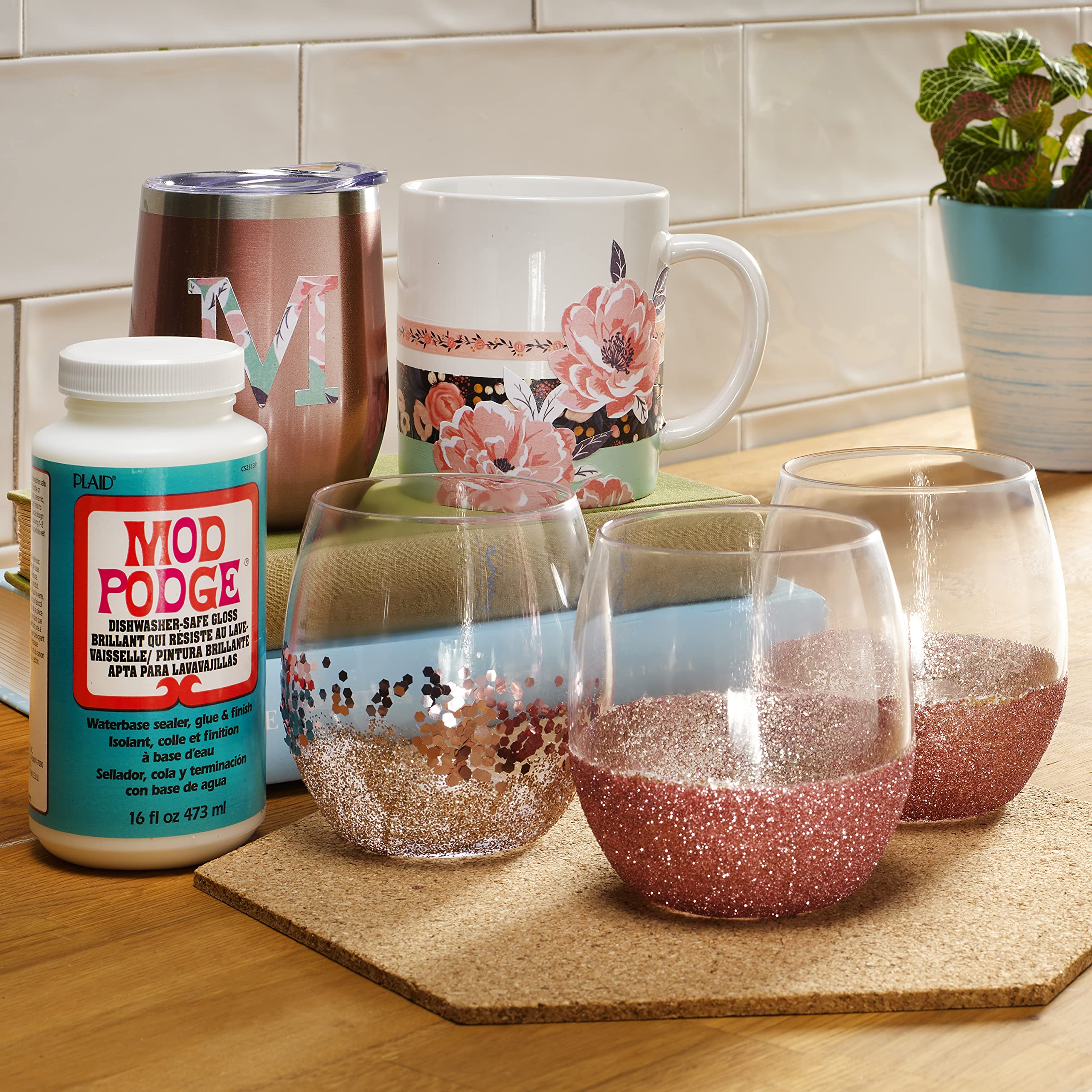 Mod Podge being used on a mug decoupage project to create dishwasher-safe art