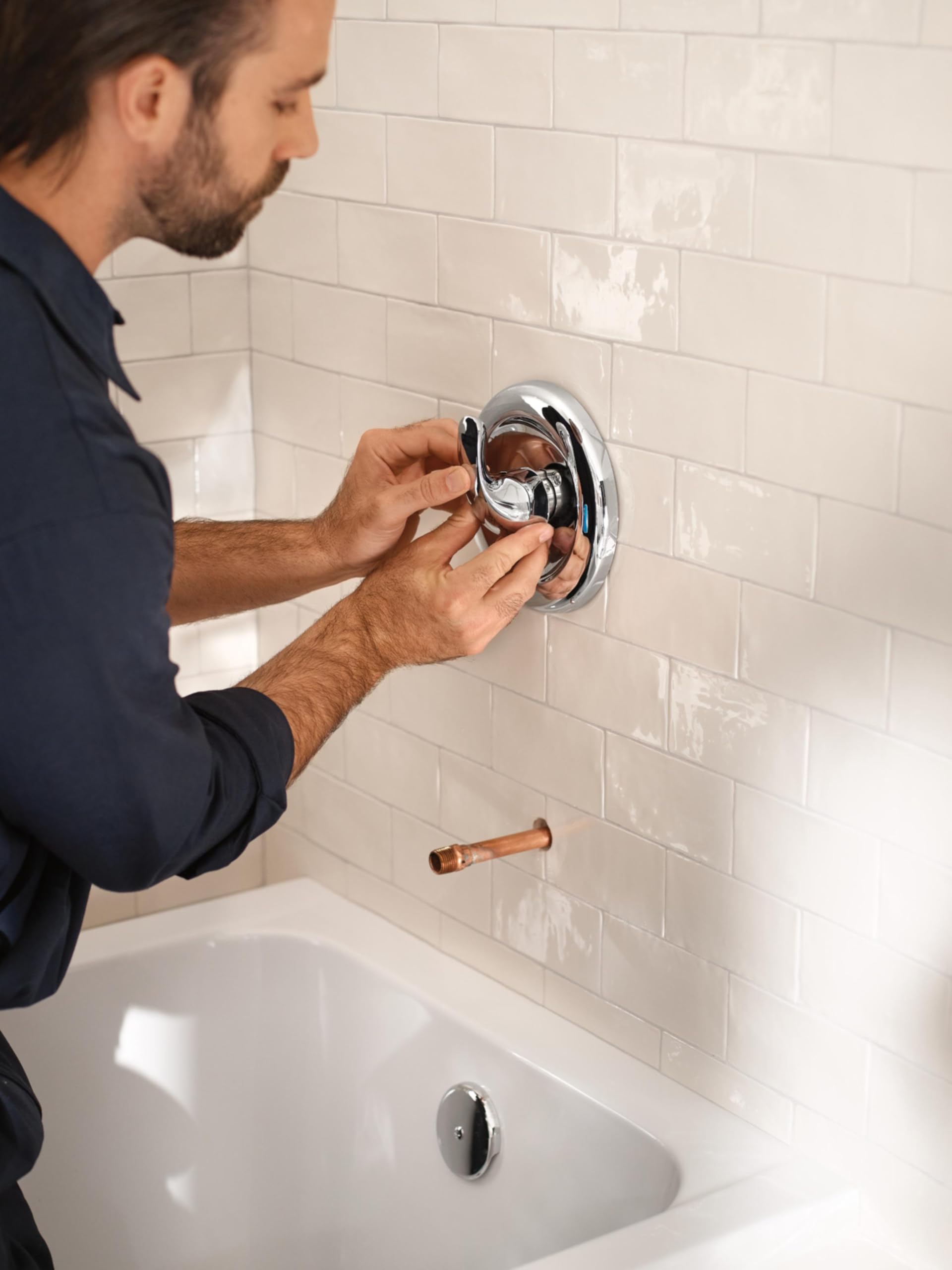 Moen PosiTemp 2510 next to ruler for size scale showing compact footprint benefit