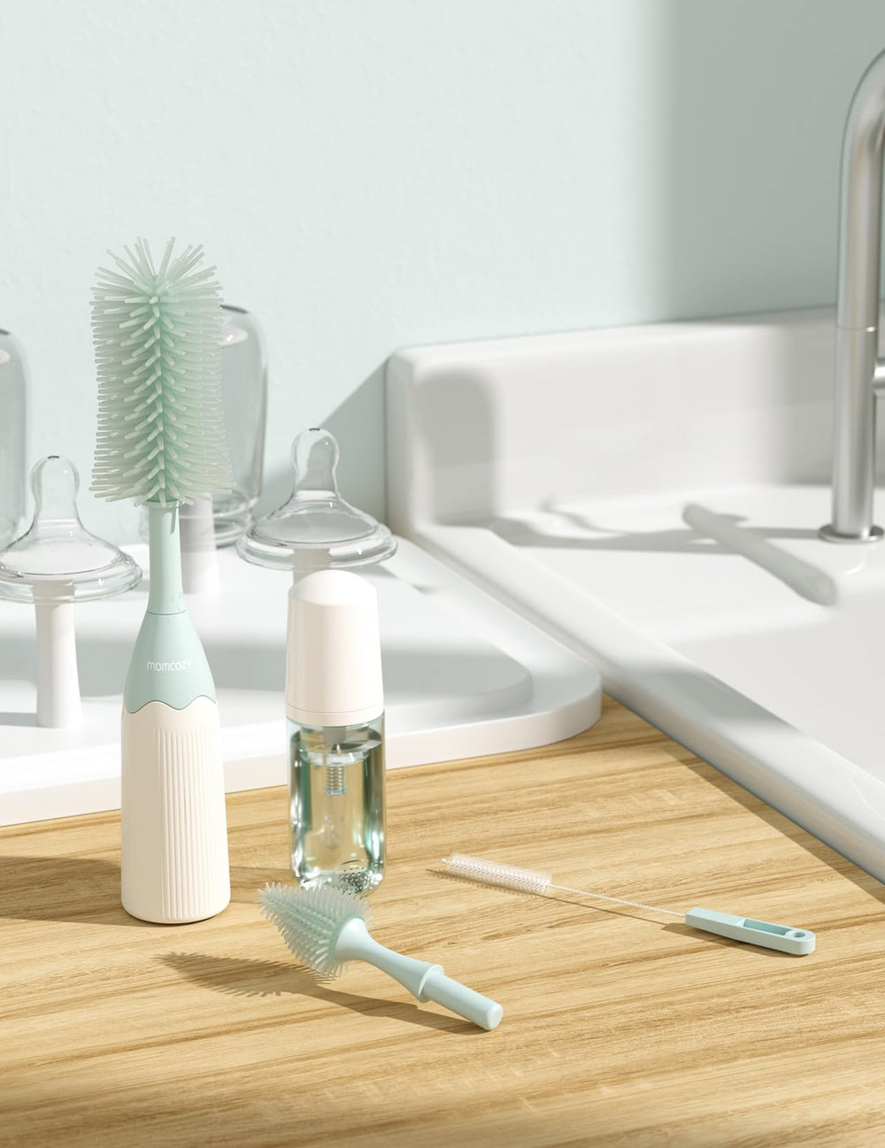 Momcozy brush hanging to dry on a hook for hygienic storage and quick air-drying