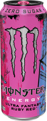 Monster Ultra Fantasy Ruby Red can next to hand showing 16 oz size for scale