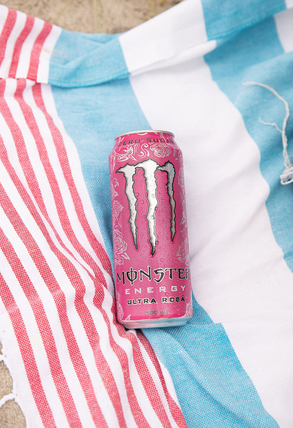 Monster Ultra Rosa can on picnic table outdoors, conveys energizing refreshment on the go