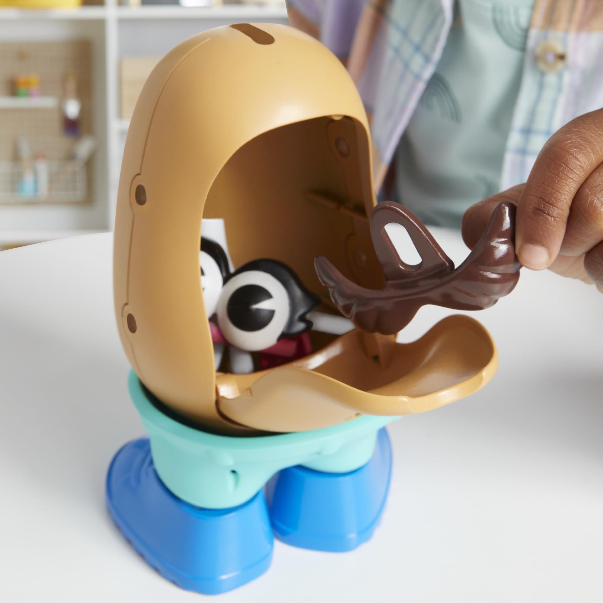 Child playing with Mr. Potato Head set encouraging creativity and fine motor skills