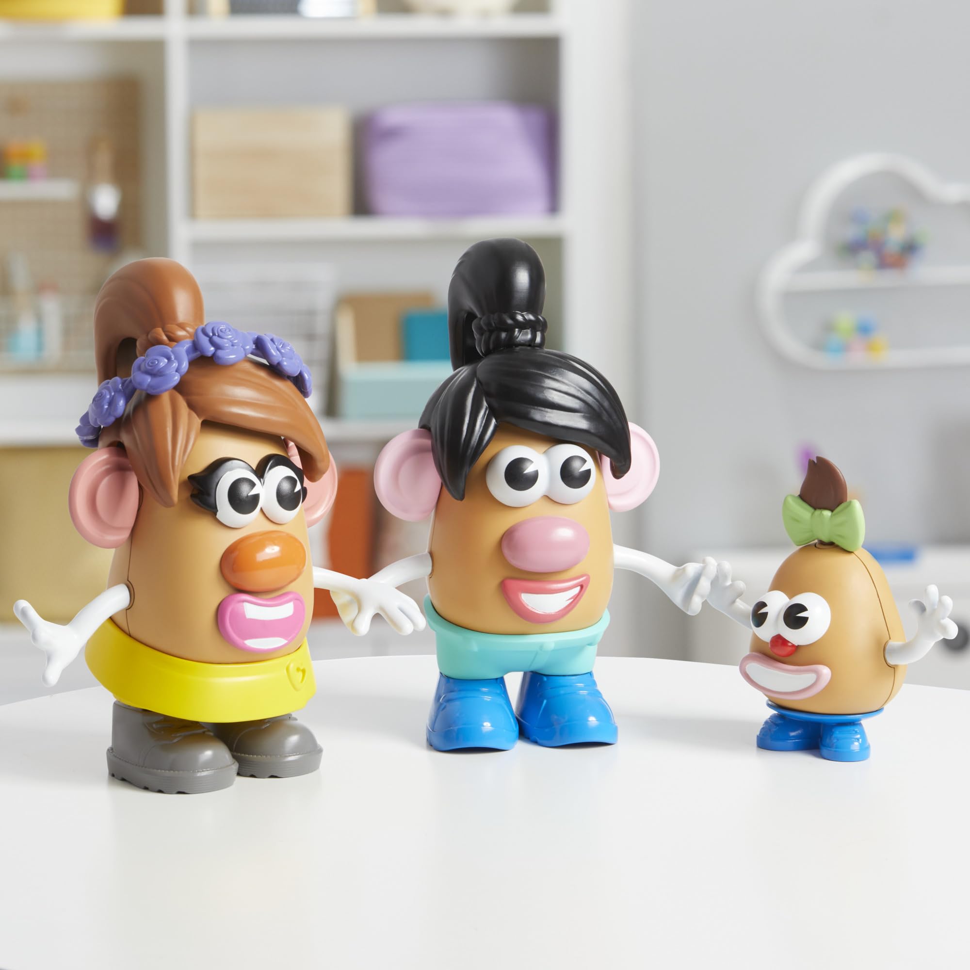 Hand holding Mr. Potato Head pieces illustrating toddler-friendly size and scale