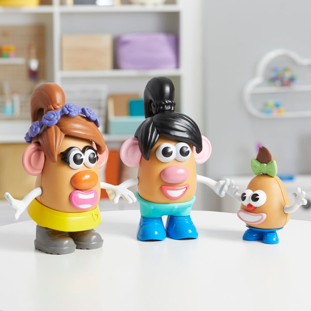 Hand holding Mr. Potato Head pieces illustrating toddler-friendly size and scale