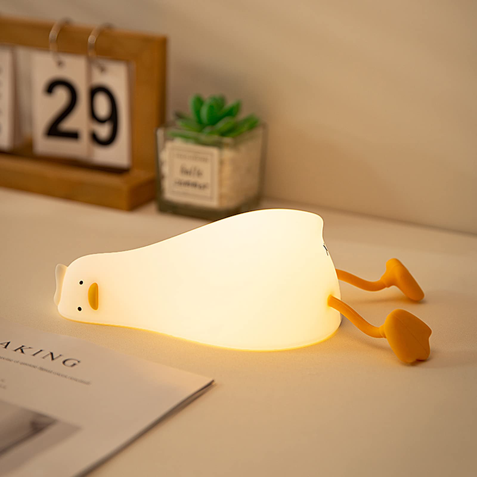 MUID Benson Duck lying flat front view showing warm glow and friendly face for comfort