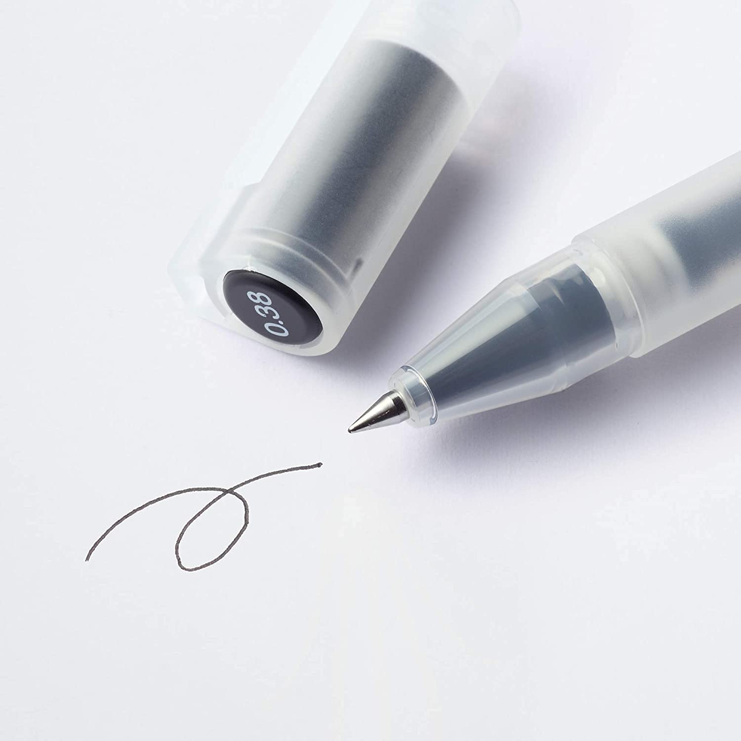 MUJI pen in hand writing in a notebook, showing comfortable grip and smooth ink flow
