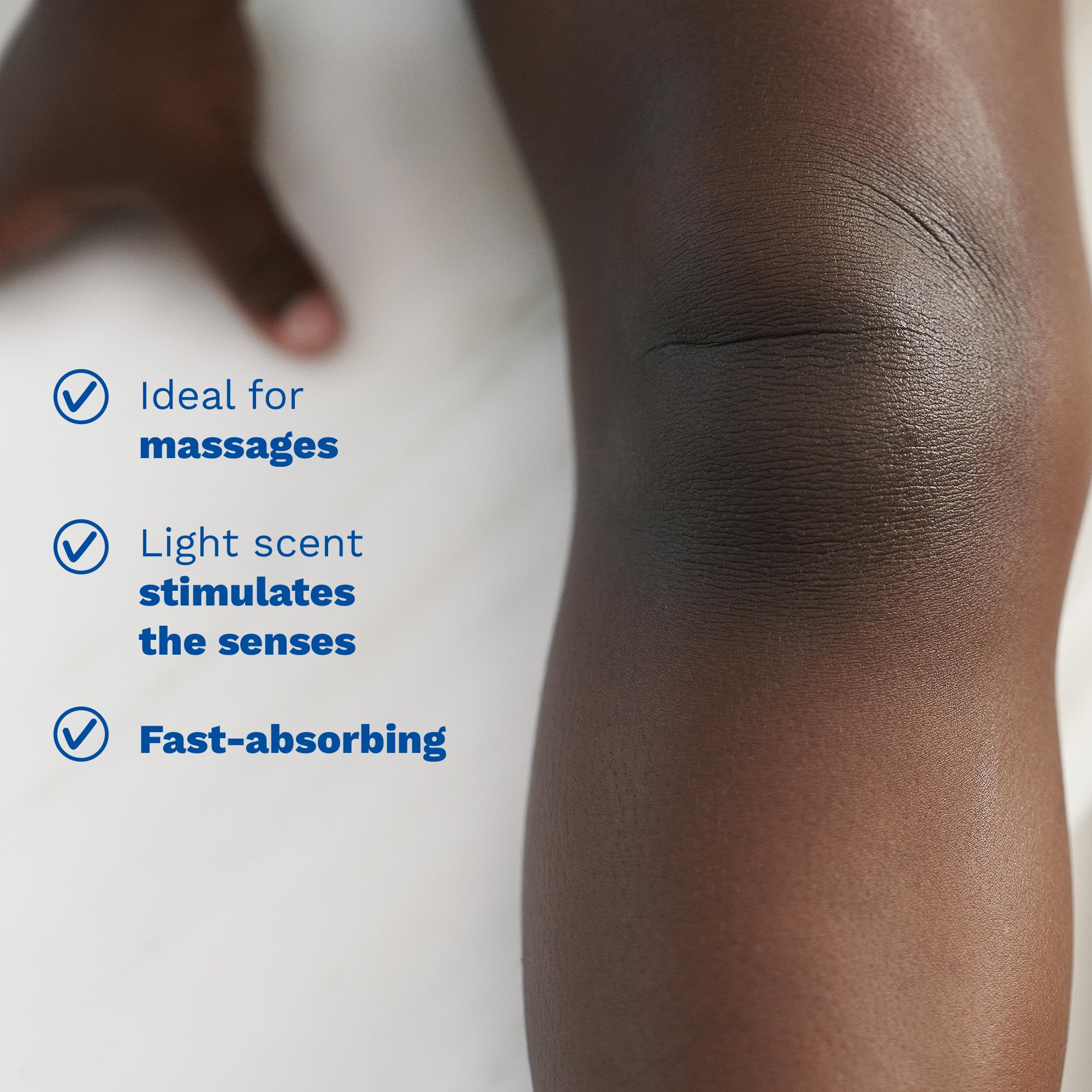 Mustela baby oil clear drop on finger demonstrating lightweight, fast-absorbing feel