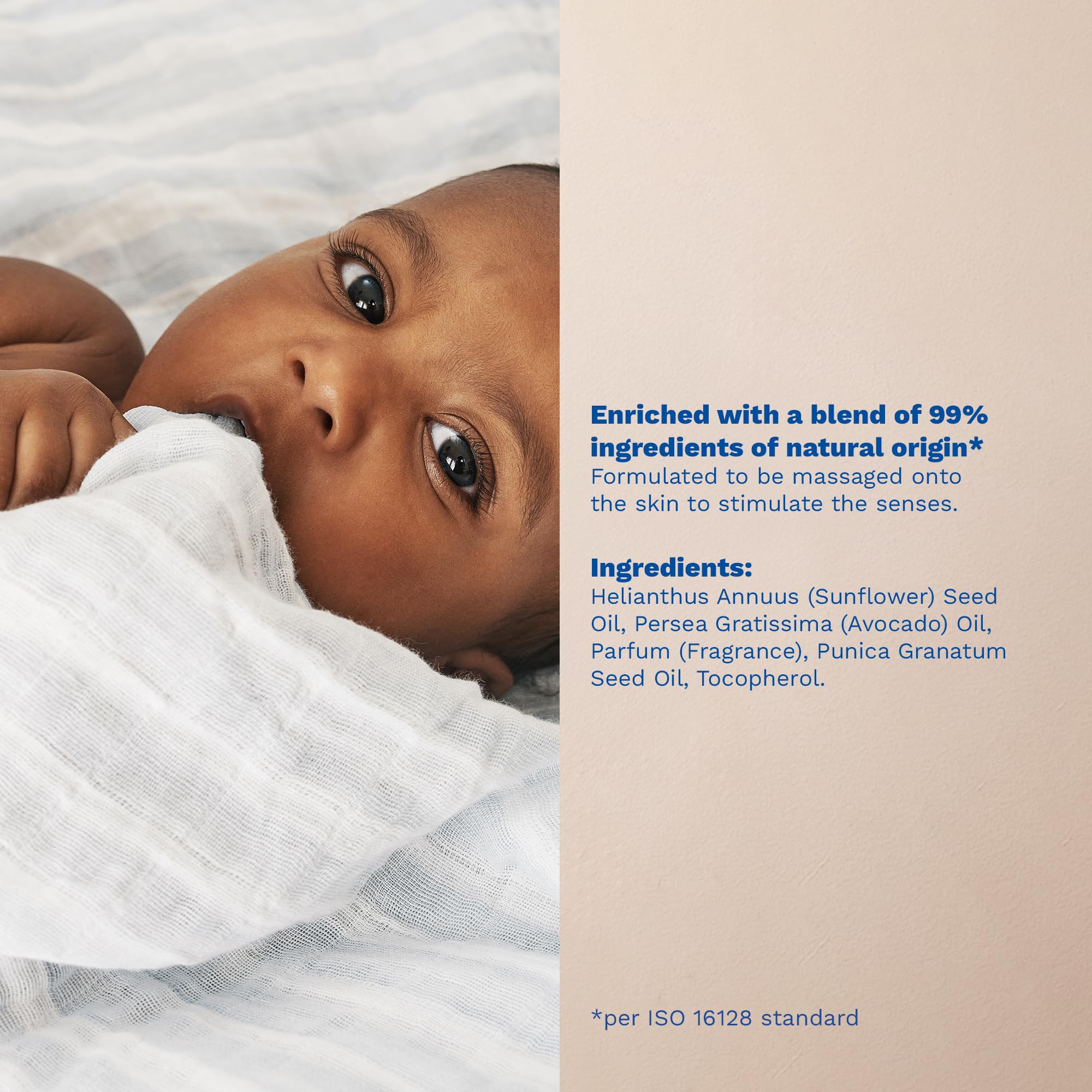 Mustela baby oil held in adult hand to show 3.38 fl. oz. scale and portability