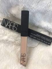NARS concealer being applied under eye demonstrating brightening and crease-resistant benefit