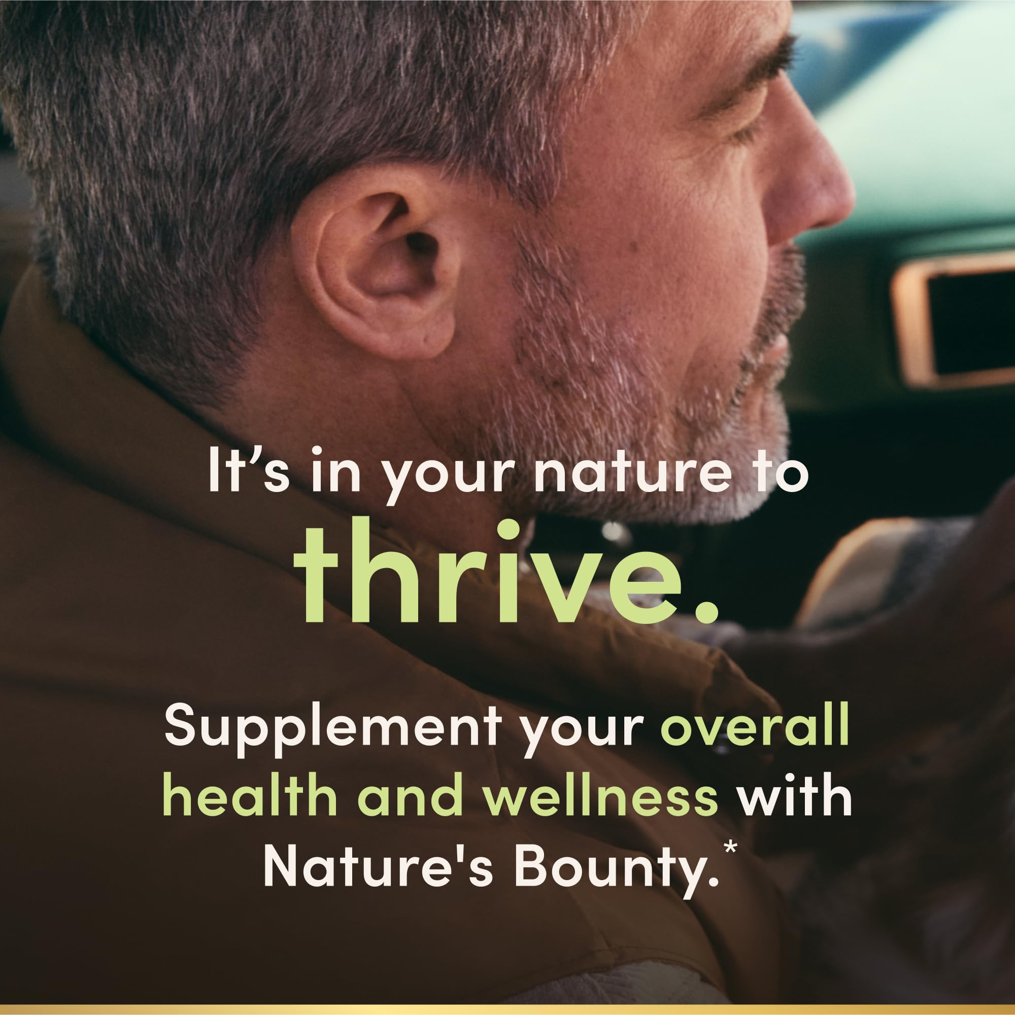 Nature's Bounty capsule resting in an open hand, demonstrating portable use benefit