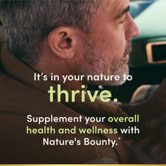 Nature's Bounty capsule resting in an open hand, demonstrating portable use benefit