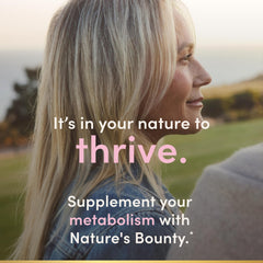 Nature's Bounty capsules in hand demonstrating serving size and travel-friendly convenience
